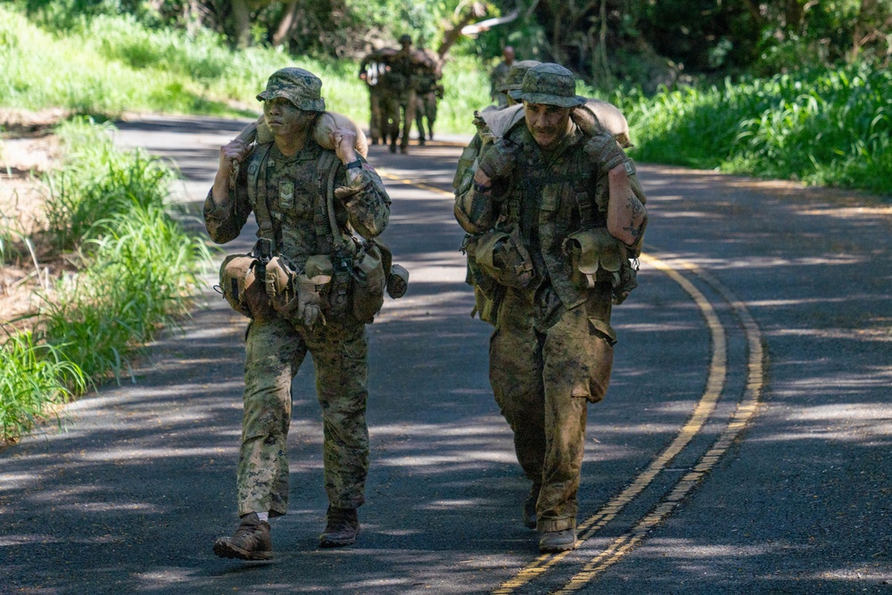 Multinational Soldiers hike Kolekole Pass at the 2026 Pacific Land Forces Team Readiness Challenge
