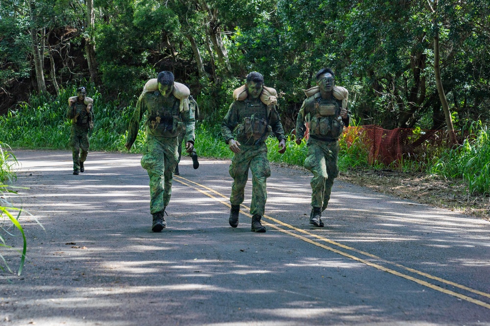 Multinational Soldiers hike Kolekole Pass at the 2026 Pacific Land Forces Team Readiness Challenge