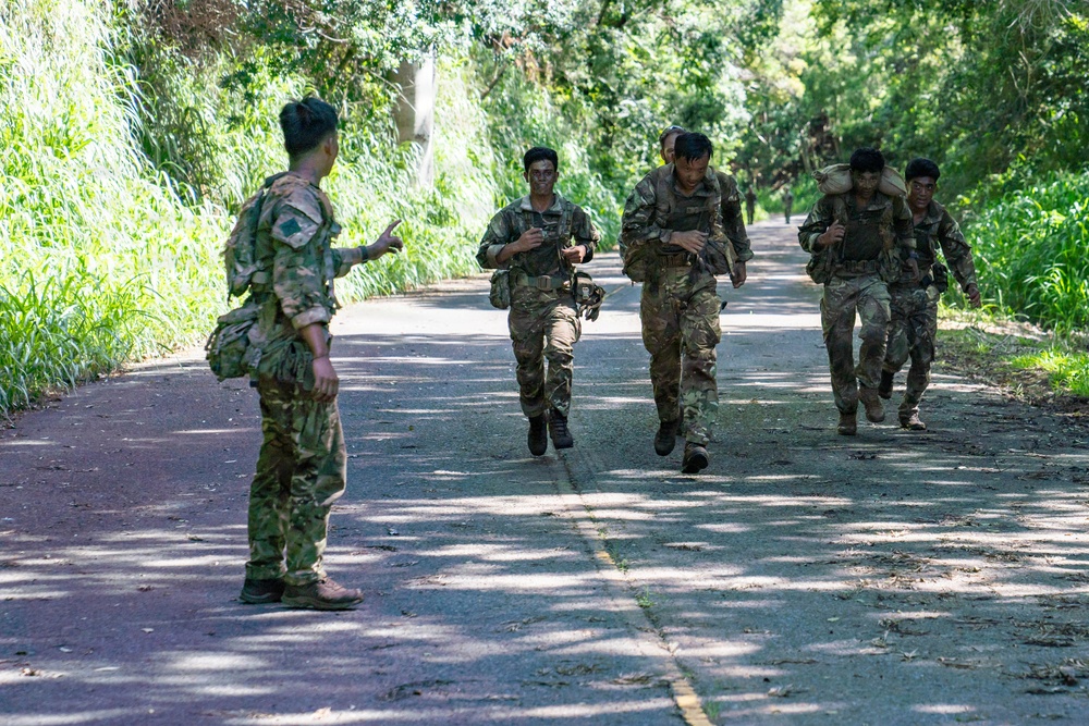 Multinational Soldiers hike Kolekole Pass at the 2026 Pacific Land Forces Team Readiness Challenge