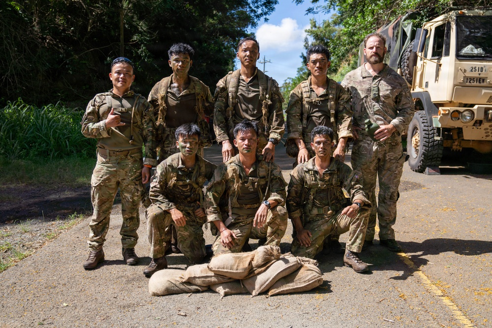 Multinational Soldiers hike Kolekole Pass at the 2026 Pacific Land Forces Team Readiness Challenge
