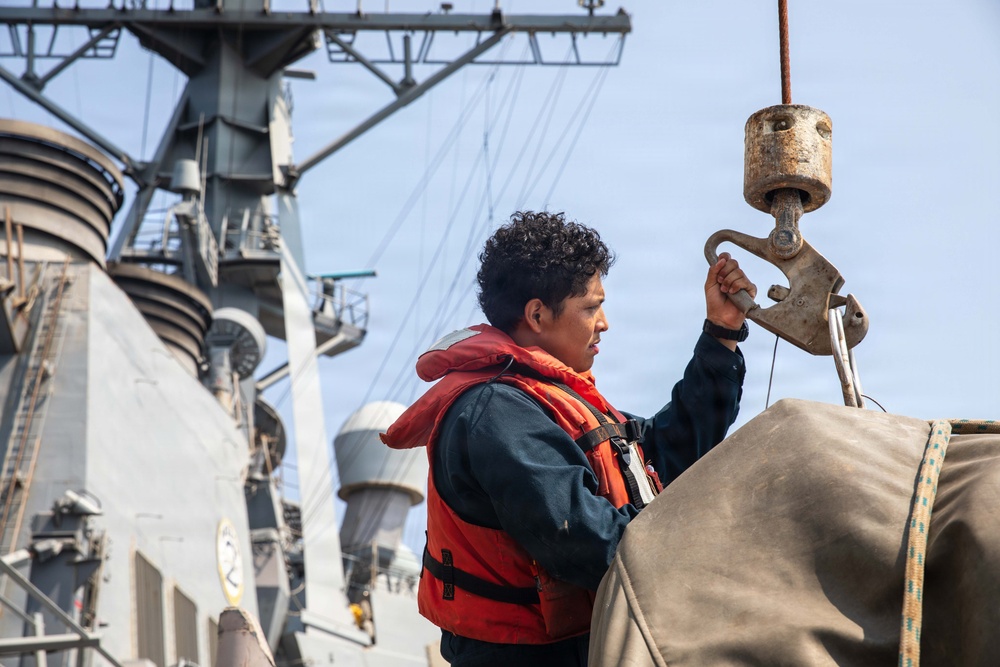 USS Mitscher (DDG 57) Sailor secures hoist during boat operations