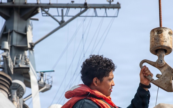 USS Mitscher (DDG 57) Sailor secures hoist during boat operations