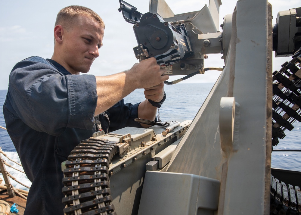USS Mitscher (DDG 57) Sailor inspects 25mm gun