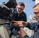 USS Mitscher (DDG 57) Sailors inspect 25mm machine gun