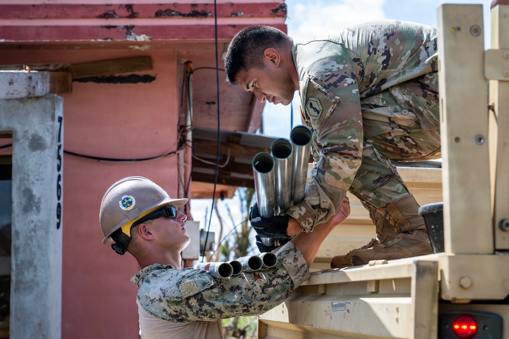 Sailors and Soldiers construct temporary shelters for Saipan residents affected by Super Typhoon Sinlaku