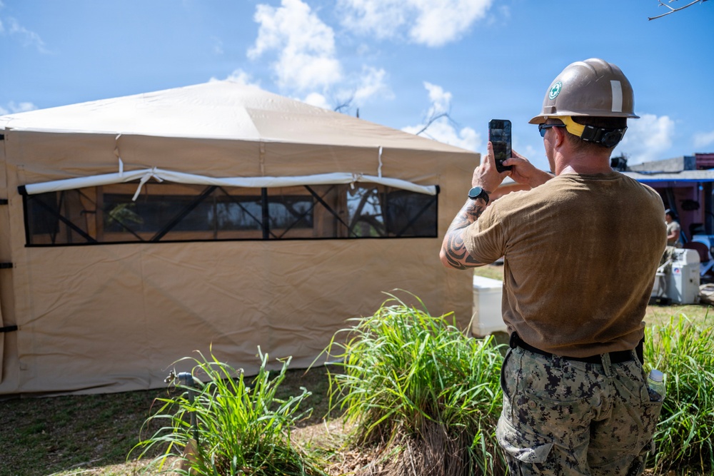 Sailors and Soldiers construct temporary shelters for Saipan residents affected by Super Typhoon Sinlaku