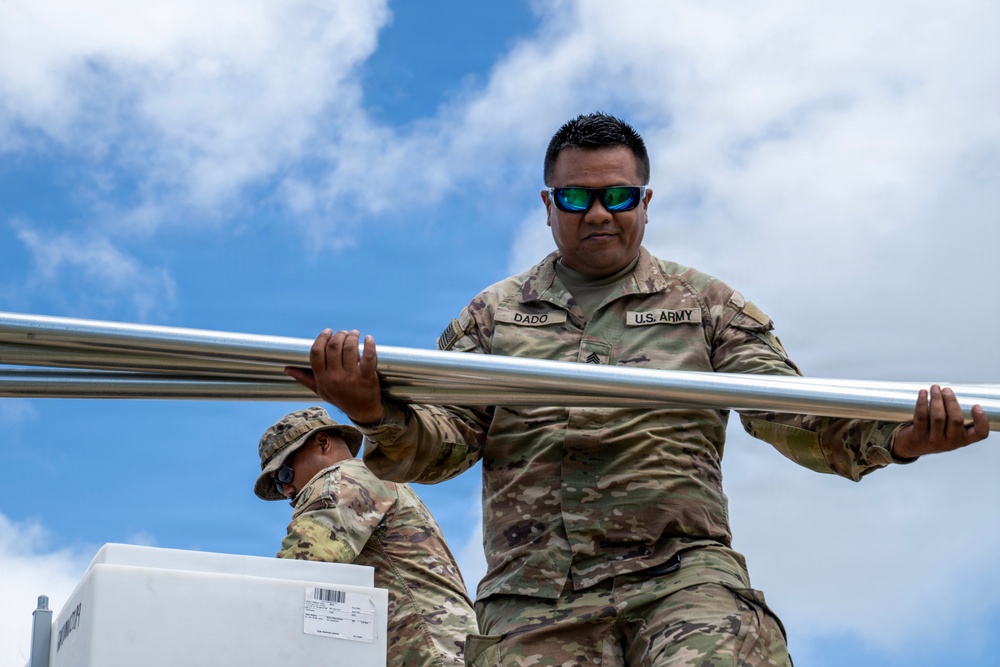 Sailors and Soldiers construct temporary shelters for Saipan residents affected by Super Typhoon Sinlaku