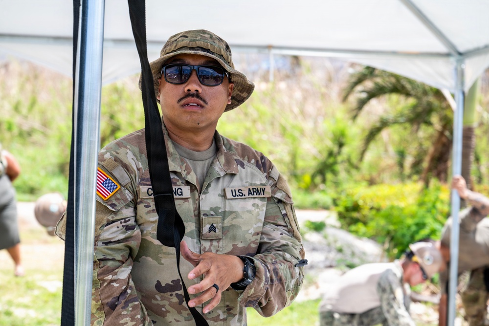 Sailors and Soldiers construct temporary shelters for Saipan residents affected by Super Typhoon Sinlaku