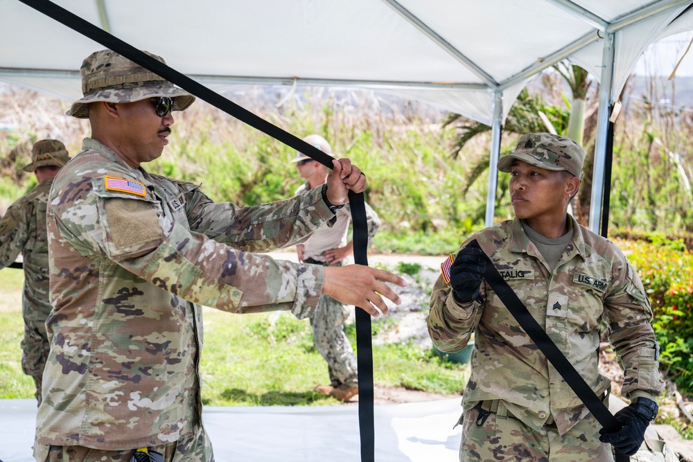 Sailors and Soldiers construct temporary shelters for Saipan residents affected by Super Typhoon Sinlaku