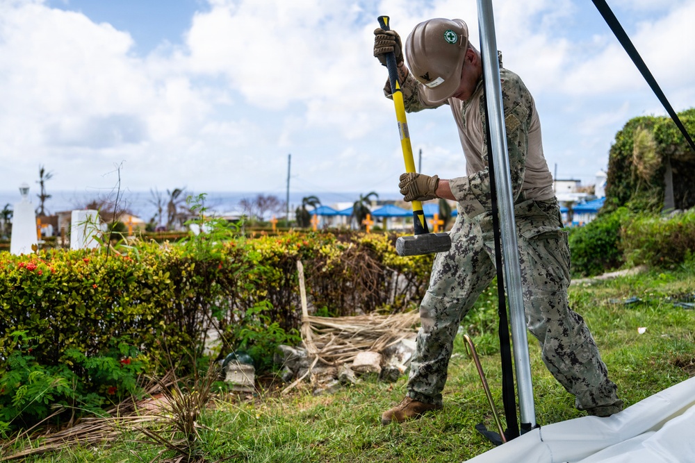 Sailors and Soldiers construct temporary shelters for Saipan residents affected by Super Typhoon Sinlaku