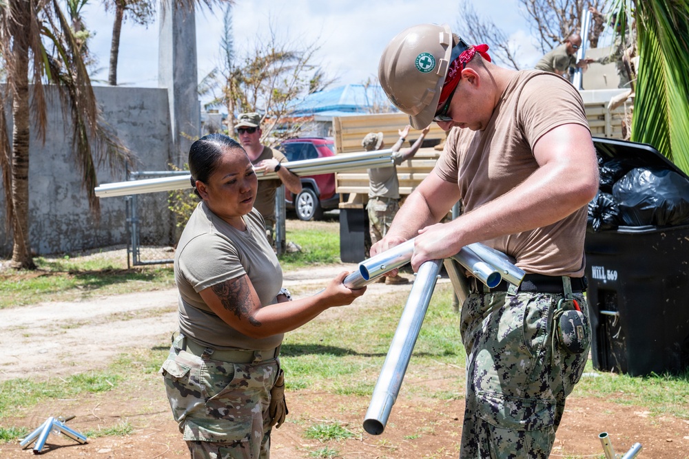 Sailors and Soldiers construct temporary shelters for Saipan residents affected by Super Typhoon Sinlaku