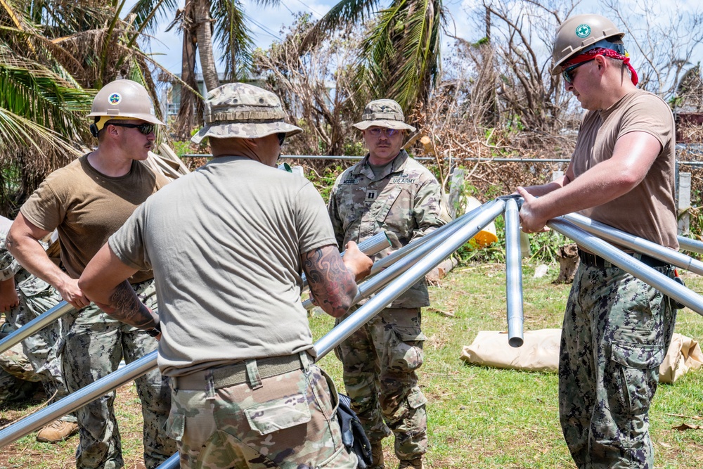 Sailors and Soldiers construct temporary shelters for Saipan residents affected by Super Typhoon Sinlaku
