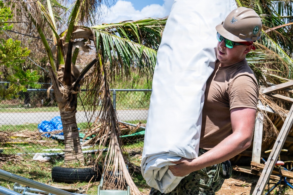 Sailors and Soldiers construct temporary shelters for Saipan residents affected by Super Typhoon Sinlaku