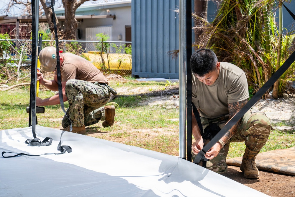 Sailors and Soldiers construct temporary shelters for Saipan residents affected by Super Typhoon Sinlaku