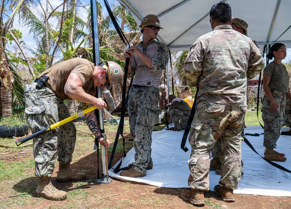 Sailors and Soldiers construct temporary shelters for Saipan residents affected by Super Typhoon Sinlaku