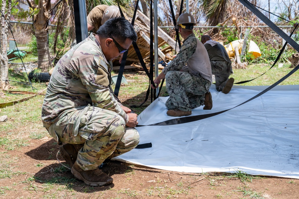 Sailors and Soldiers construct temporary shelters for Saipan residents affected by Super Typhoon Sinlaku