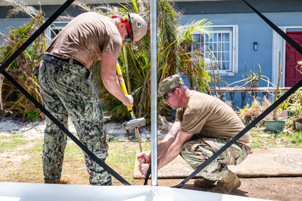 Sailors and Soldiers construct temporary shelters for Saipan residents affected by Super Typhoon Sinlaku