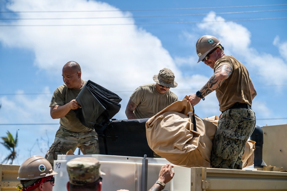 Sailors and Soldiers construct temporary shelters for Saipan residents affected by Super Typhoon Sinlaku