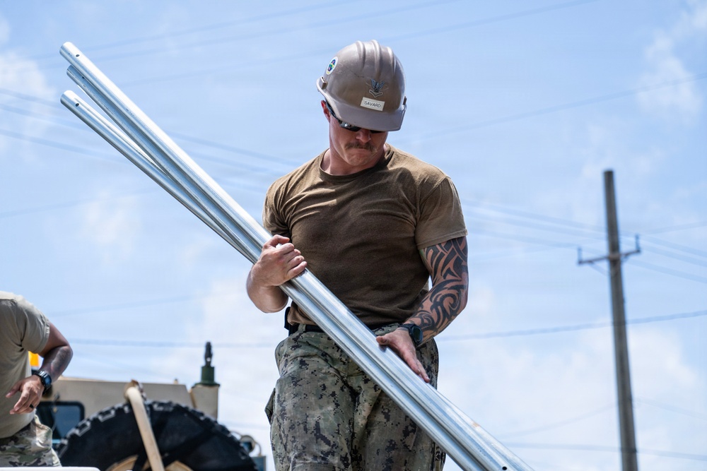 Sailors and Soldiers construct temporary shelters for Saipan residents affected by Super Typhoon Sinlaku