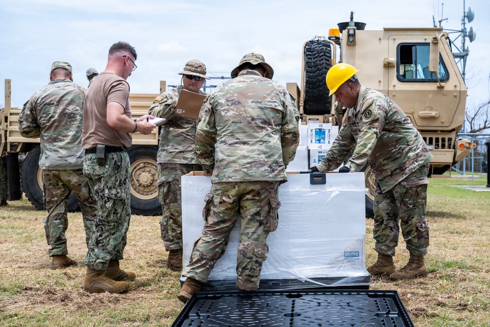 Sailors and Soldiers deliver emergency supplies for Saipan residents affected by Super Typhoon Sinlaku