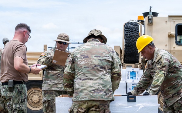 Sailors and Soldiers deliver emergency supplies for Saipan residents affected by Super Typhoon Sinlaku