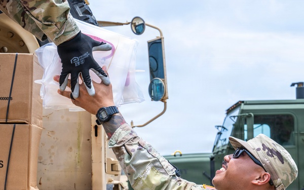Sailors and Soldiers deliver emergency supplies for Saipan residents affected by Super Typhoon Sinlaku