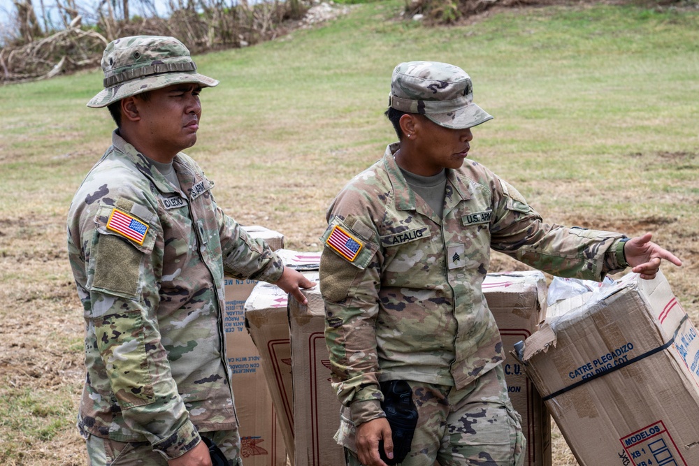Sailors and Soldiers deliver emergency supplies for Saipan residents affected by Super Typhoon Sinlaku