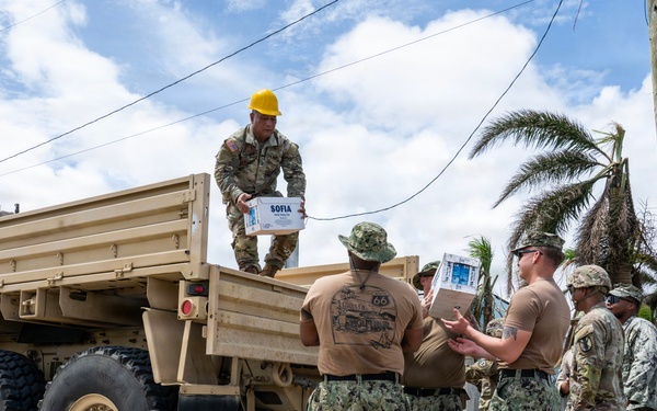 Sailors and Soldiers deliver emergency supplies for Saipan residents affected by Super Typhoon Sinlaku