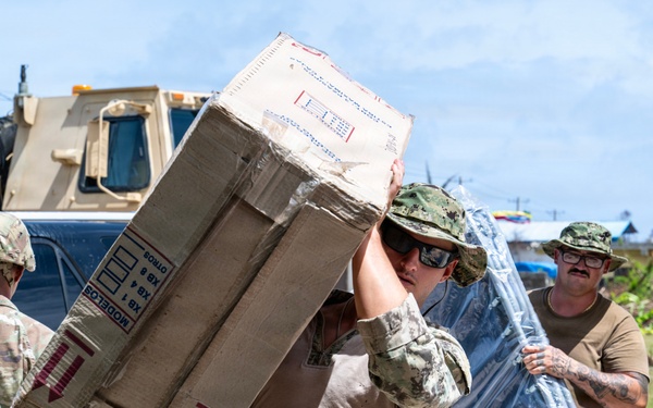 Sailors and Soldiers deliver emergency supplies for Saipan residents affected by Super Typhoon Sinlaku