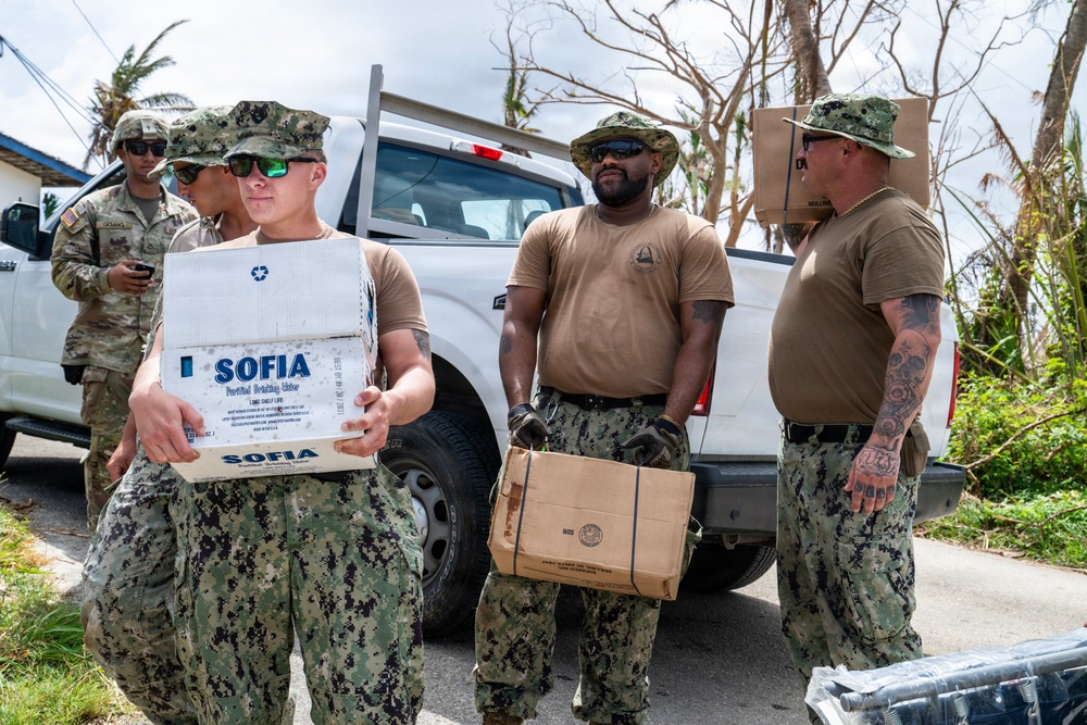 Sailors and Soldiers deliver emergency supplies for Saipan residents affected by Super Typhoon Sinlaku