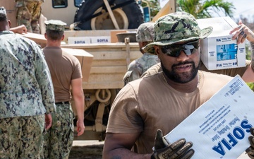 Sailors and Soldiers deliver emergency supplies for Saipan residents affected by Super Typhoon Sinlaku