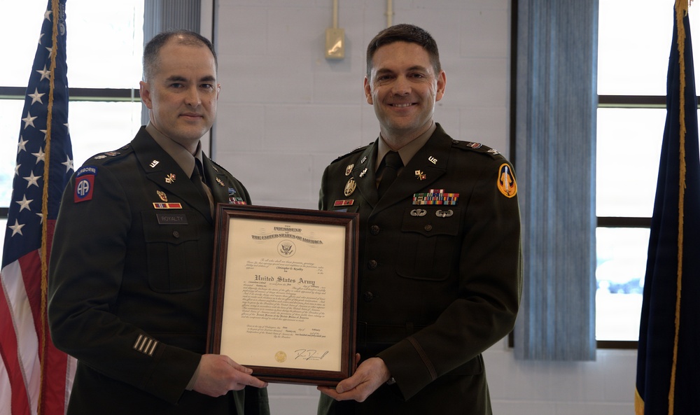 U.S. Army Officers Pose with Framed Presidential Certificate During Military Ceremony