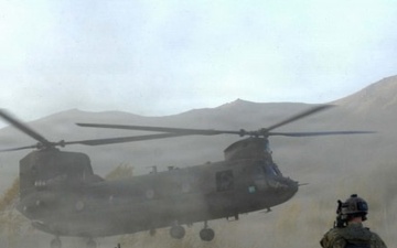 PM ASE - Soldiers brace themselves against the CH-47 Chinook helicopter rotor wash