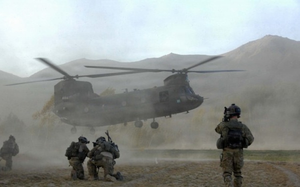 PM ASE - Soldiers brace themselves against the CH-47 Chinook helicopter rotor wash