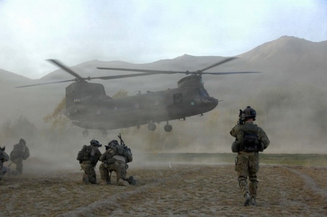 PM ASE - Soldiers brace themselves against the CH-47 Chinook helicopter rotor wash