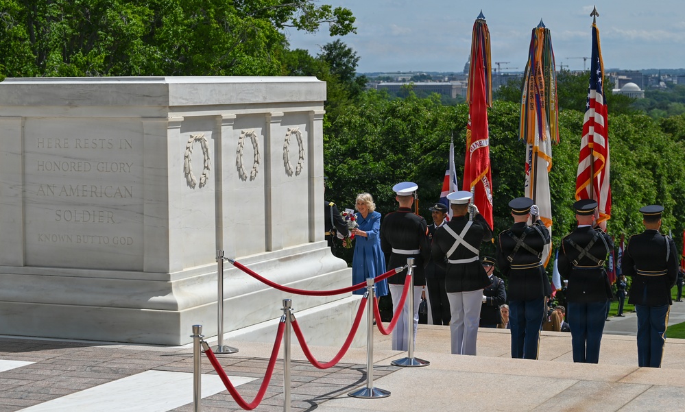 Queen Camilla receives a flower bouquet to place at the Tomb of the Unknown Soldier