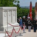 Queen Camilla receives a flower bouquet to place at the Tomb of the Unknown Soldier