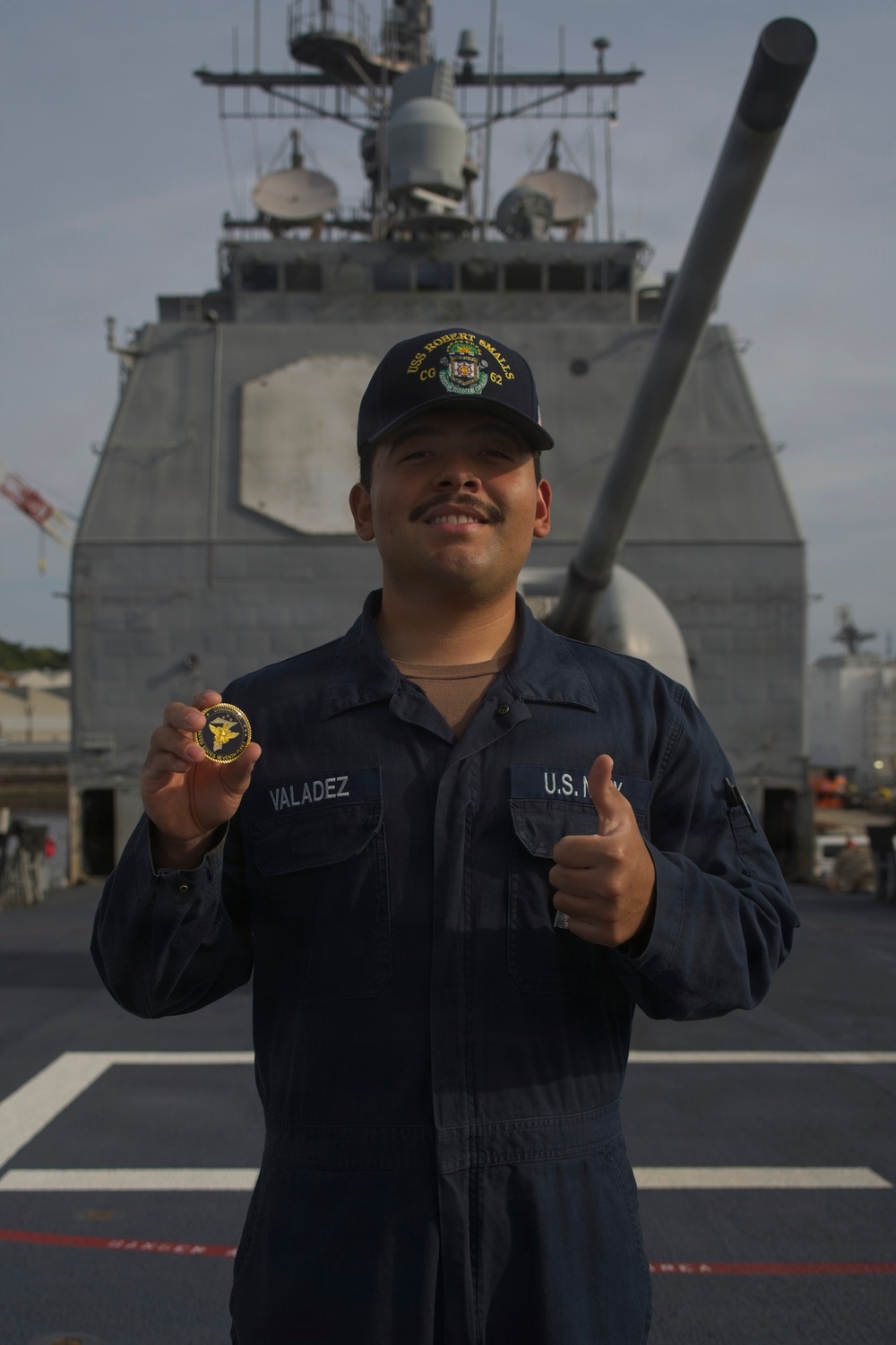 U.S. Navy Sailor Valadez Displays Challenge Coin Aboard USS Robert Smalls (CG-62)