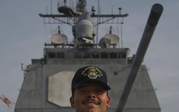 U.S. Navy Sailor Valadez Displays Challenge Coin Aboard USS Robert Smalls (CG-62)