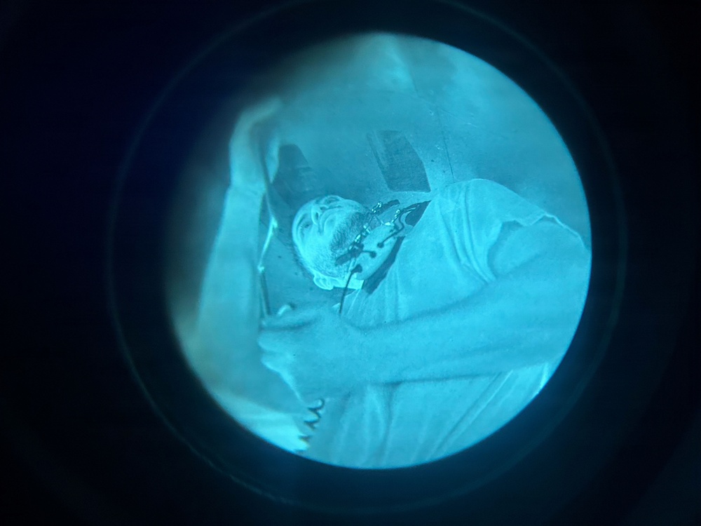 Night Vision Optic View of Injured or Resting Individual During Nighttime Medical or Rescue Operation