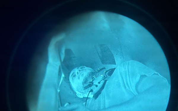 Night Vision Optic View of Injured or Resting Individual During Nighttime Medical or Rescue Operation