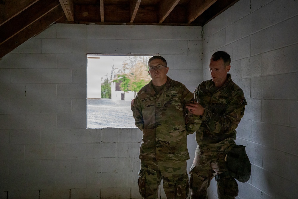 Region II Best Warrior Competitors search a detainee during Range Run