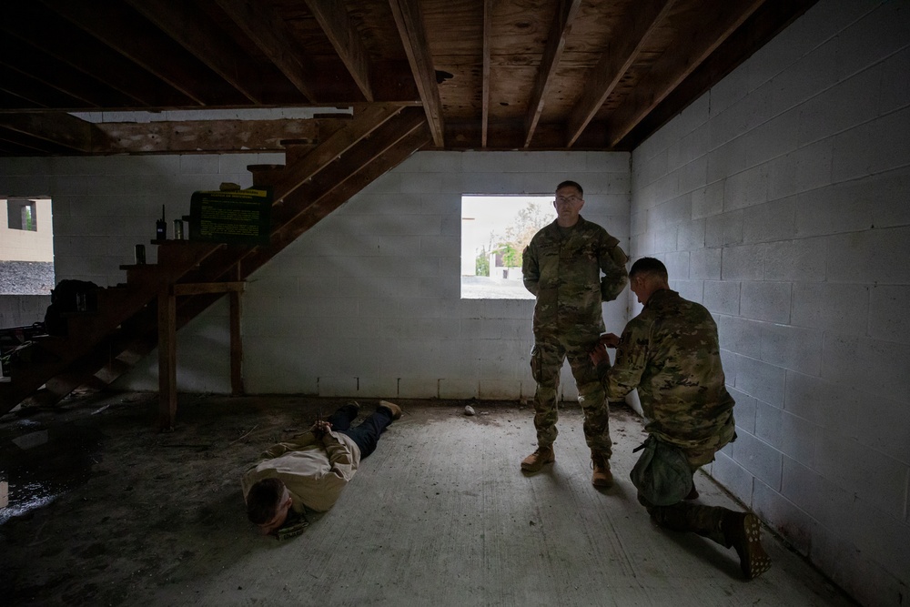 Region II Best Warrior Competitors search a detainee during Range Run