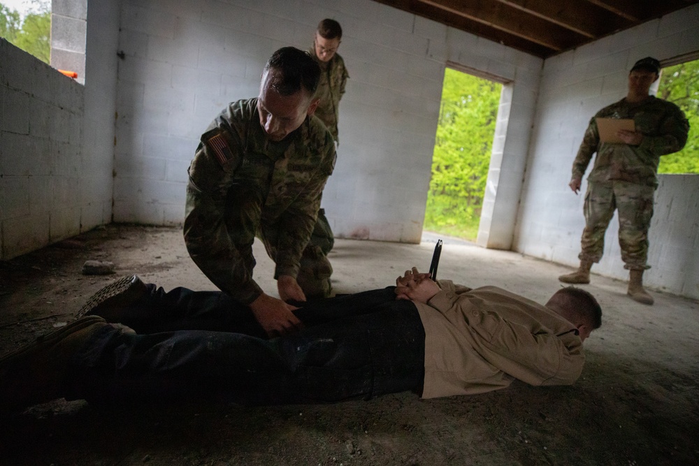 Region II Best Warrior Competitors search a detainee during Range Run