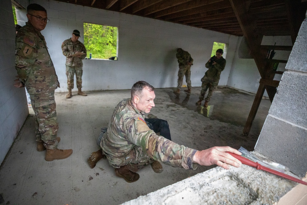 Region II Best Warrior Competitors search a detainee during Range Run
