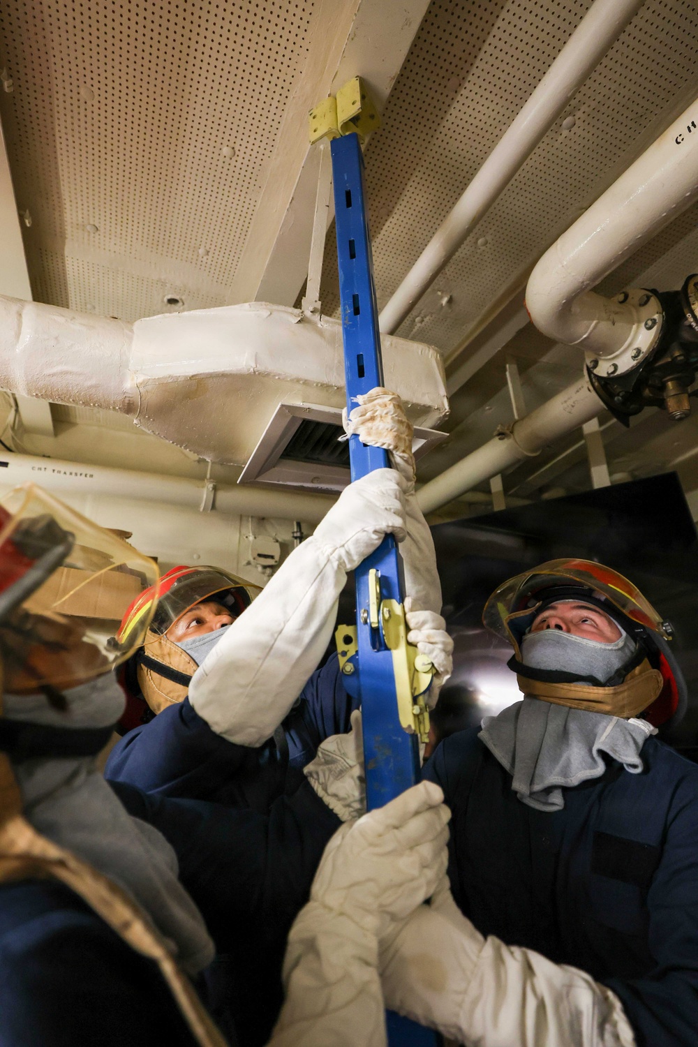 Sailors use metal shoring for damage control drill onboard USS Lake Erie (CG 70)
