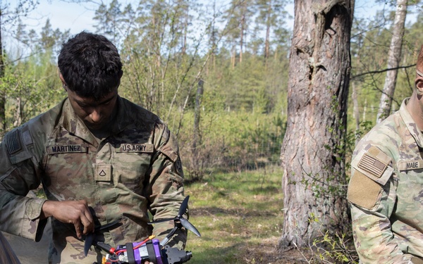 U.S. Soldiers from the 1st Squadron, 2d Cavalry Regiment assemble and tests drones