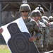 U.S. Army soldiers inspect paper targets during marksmanship qualification training at a firing range