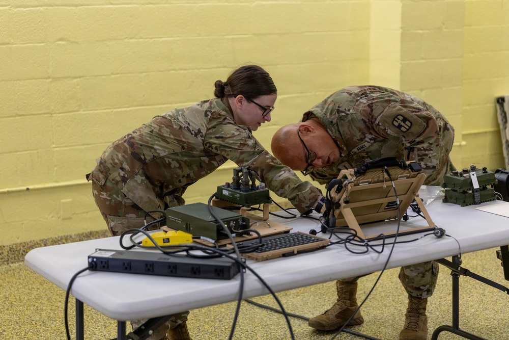 U.S. Army Reserve soldiers configure military communications equipment during training exercise