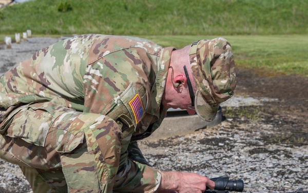 Soldier Adjusts Weapon